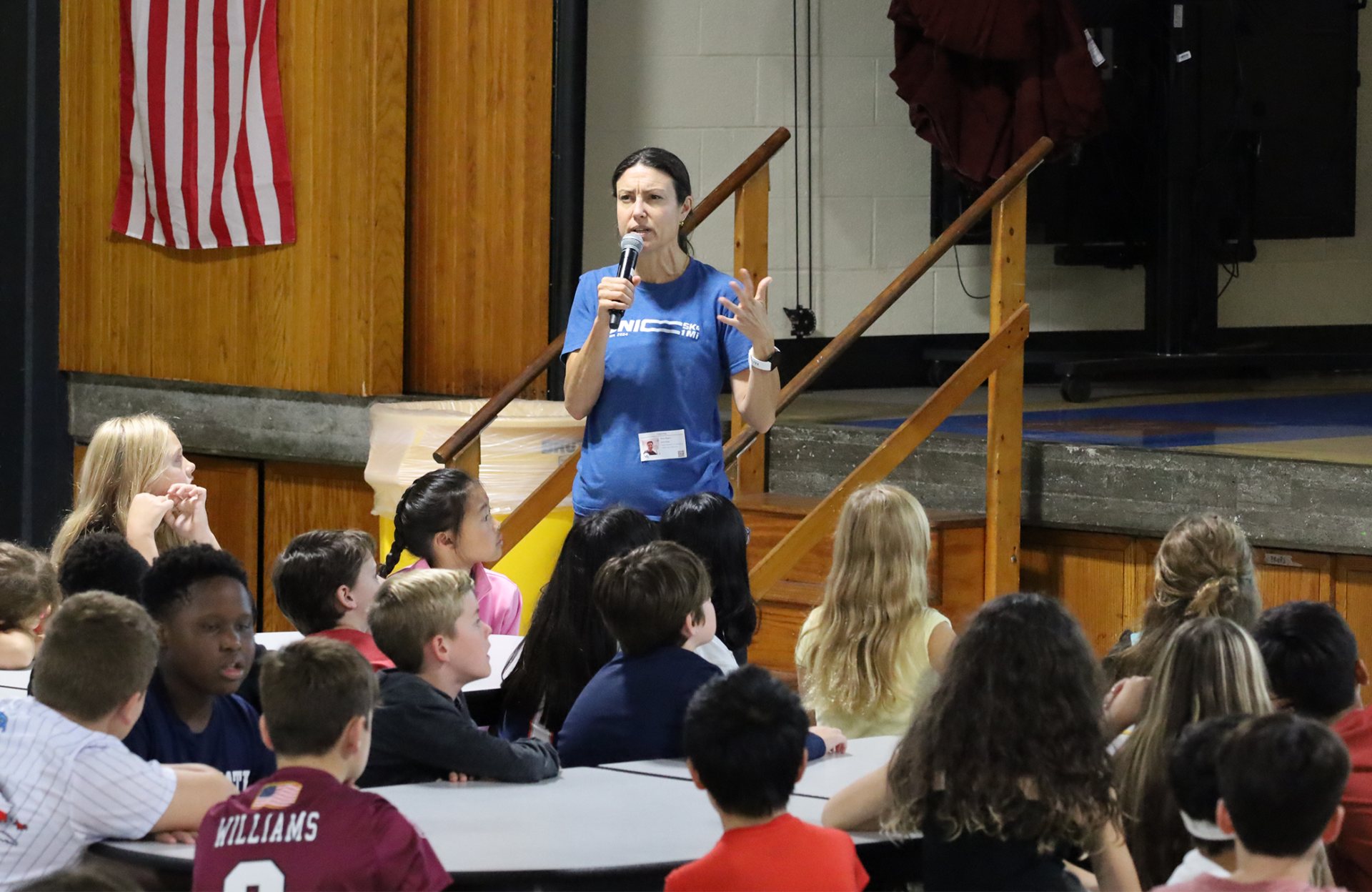 Dana Ross Rogers of Bionic Project speaks during an assembly for fifth graders in the cafeteria at Parker Middle School in Chelmsford.